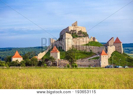 Rupea Romania - June 23 2013: Tourists visiting the old medieval fortress on top of the hill Rupea village located in Transylvania Romania