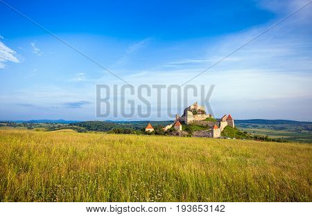 Rupea Romania - June 23 2013: Tourists visiting the old medieval fortress on top of the hill Rupea village located in Transylvania Romania