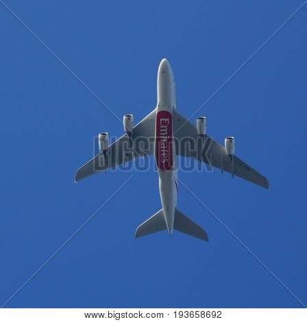 Almere, The Netherlands - July 3, 2017: Emirates Airbus A380-800 (A6-EDR) flies above the city of Almere.