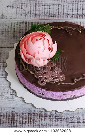 chocolate blueberry cheesecake with chocolate peony and isomalt decoration