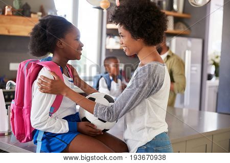 Mother Saying Goodbye To Daughter As She Leaves For School