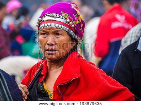 MUANG SING, LAOS - DECEMBER 28, 2012: Elderly woman in the morning market in the village of Muang Sing Laos