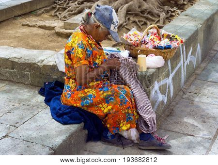 OAXACA MEXICO - MARCH 4: Woman selling candy in a street market in Oxaca Mexico on March 4 2017