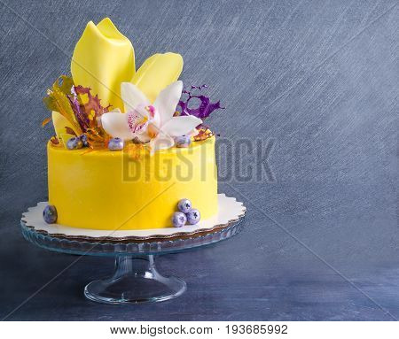 yellow cream cheese cake with chocolate twist and isomalt decoration