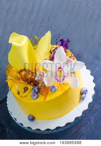 yellow cream cheese cake with chocolate twist and isomalt decoration