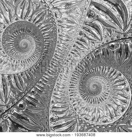 Silver metal abstract spiral fractal pattern background. Lattin floral pattern. Metallic paper spiral background. Traditional silver ornament pattern background. Spiral effect pattern background