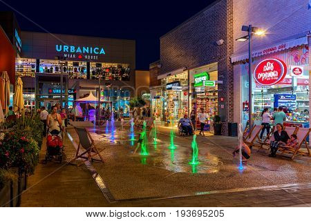 ASHDOD, ISRAEL - JULY 03, 2016: Shops, boutiques and illuminated fountains in open air mall at evening - owned by BIG Shopping Centers Ltd., operates in four countries - Israel, USA, India and Serbia.
