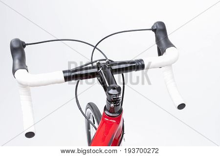 Bicycle Concept. Partial View of Professional Carbon Road Bike Handlebars With White Grip Tape. Against White. Horizontal Image Composition