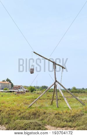Landscape with antique lighthouse from wood in France
