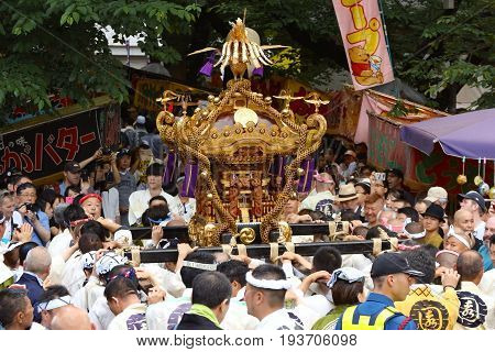 2017 05 28. SHINJUKU TOKYO JAPAN. People are carrying a portable shrine on their shoulders and walking around shinjuku city. known as OMIKOSHI MASTURI FESTIVAL at HANAZONO JINJA, SHINJUKU TOKYO JAPAN
