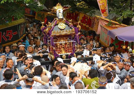 2017 05 28. SHINJUKU TOKYO JAPAN. People are carrying a portable shrine on their shoulders and walking around shinjuku city. known as OMIKOSHI MASTURI FESTIVAL at HANAZONO JINJA, SHINJUKU TOKYO JAPAN