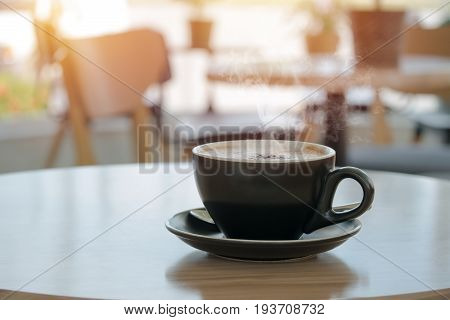 Hot cappucinno coffee on the table at coffee shop