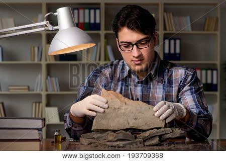 Archeologist working late night in office