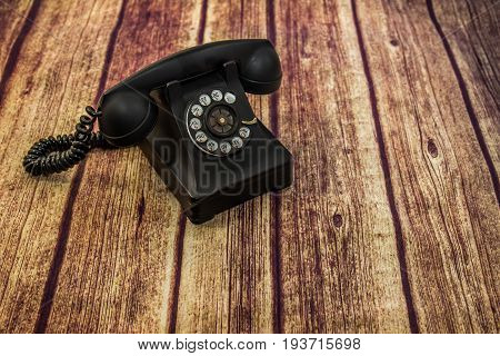 Old Rotary Style Telephone On Wood Floor
