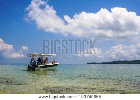Labuan,Malaysia-May 1,2017:Tropical beach background and wonderful nature landscape with sandy beach & tourist boat in Rusukan Besar island,Labuan,Malaysia.