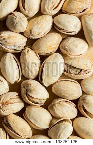 Many salt pistachio nuts full screen top view, close up