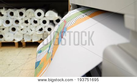 Jerusalem, Israel - May 21, 2017: Wide format printer is printing color design draft outline sketch drawing in the printing house. Design office supply equipment.