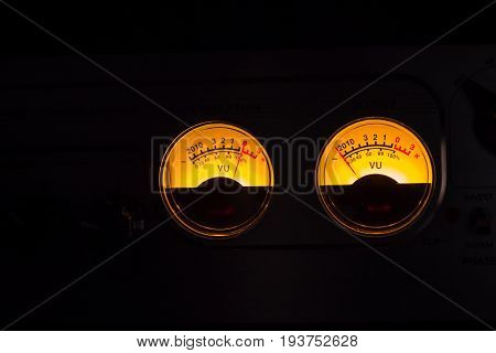 Analog Vu Meters Glowing On Black Background