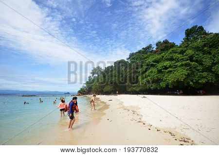 Tourists Enjoy White Sand Beach Of Sapi Island In Sabah