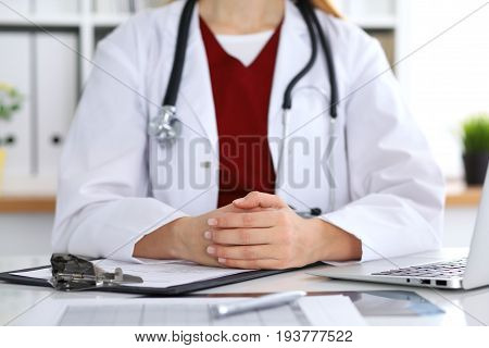 Close up of a unknown female doctor's hands. Physician is ready to consult and halp patients. Medicine and health care concept