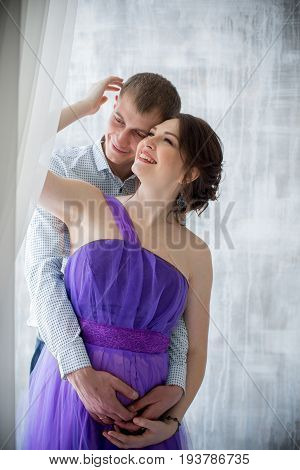 pregnant woman and man posing together in Studio, happy waiting