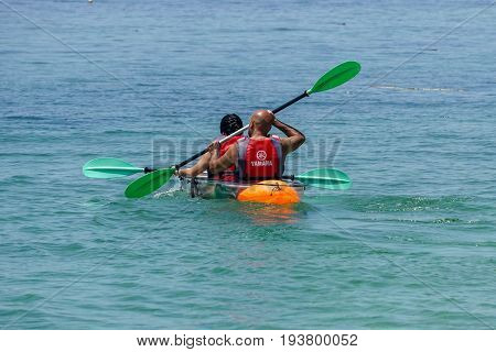 Labuan,Malaysia-May 1,2017:Group of tourist enjoying a weekend kayaking with the transparent kayak in Rusukan Besar island,Labuan,Malaysia.Labuan is the ideal place for water sports,like kayaking & scuba diving