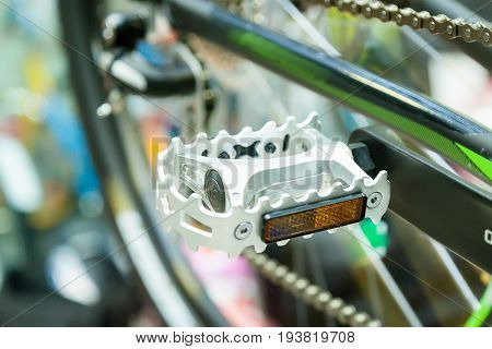 Bicycle silvery color pedal on a blurred bicycle background