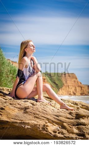 Young hot slim blonde on the beach