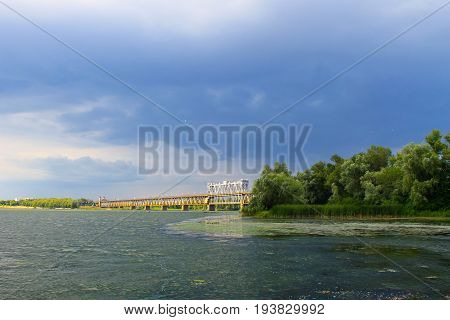 Bridge across river Dnieper in Kremenchug and storm clouds in sky