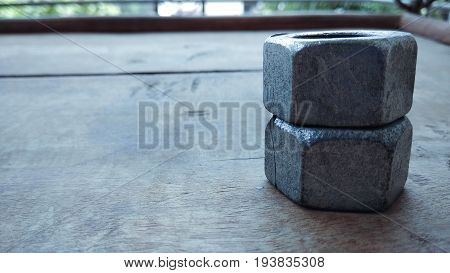 hex metal nuts on wood outdoor background