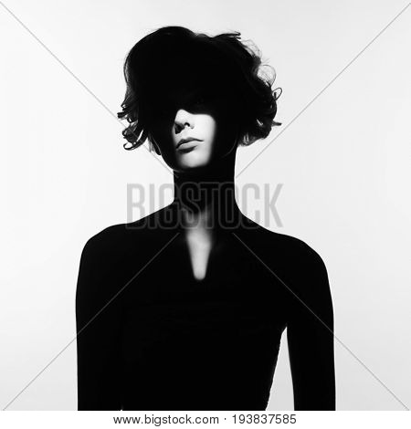 Black and white art fashion surrealistic portrait of beautiful woman with a beam of light on her face