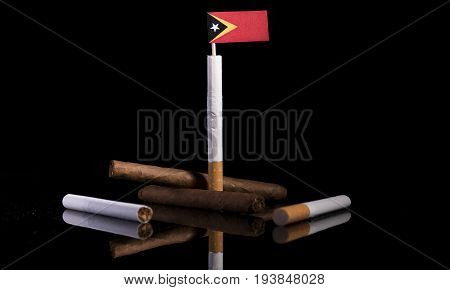 East Timorese Flag With Cigarettes And Cigars. Tobacco Industry Concept.