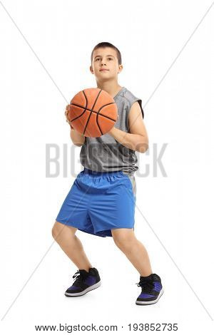 Full length portrait of a boy about to throw a basketball isolated on white background