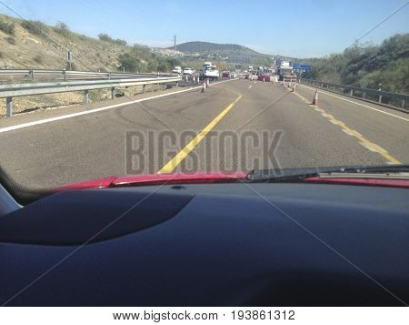 Roadworks on a highway divert traffic to a temporary road. View from the inside of the car