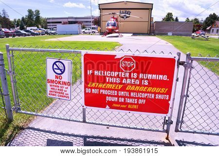 KALISPELL, MONTANA, USA - June 19, 2017: Helicopter warning sign on a gate in front of the ALERT air ambulance helipad