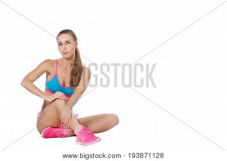 A young slender woman is engaged in fitness. Isolated white background