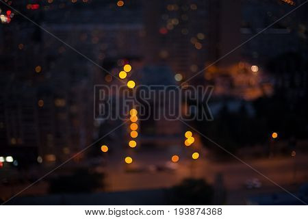 The night city is blurred. Bokeh lights the city. Defocused Background