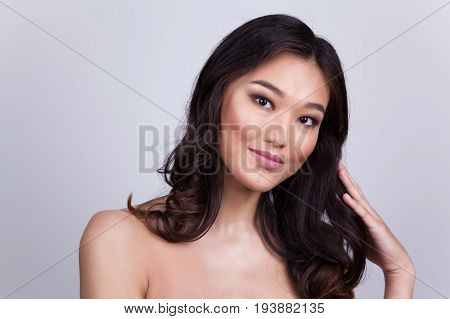 Portrait of a beautiful asian woman with naked shoulders.