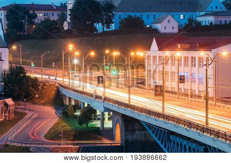 Grodno, Belarus - June 9, 2017: Night Traffic In Bridge Over The Neman River At Evening In Night Illuminations Lights. Blue Hour In Hrodna