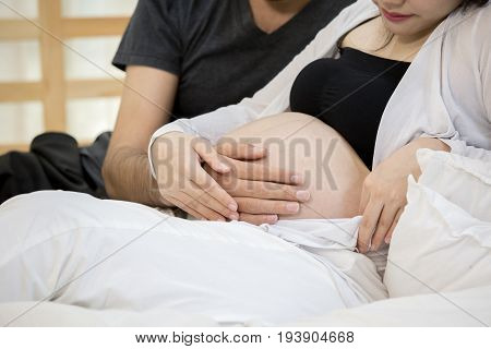 Close Up Of Hand Man Touching Pregnant Woman With Happy Emotion Together At Home.