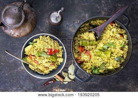 Indian Vegetable Biryani with Sweet Pepers and Zucchini as close-up in a frying pan