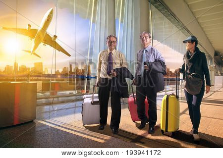 two business man and woman with traveling luggage walking in airport teminal