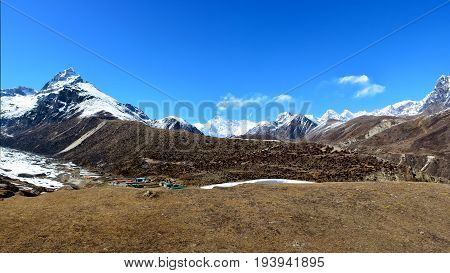 Panoramic view of the Cho-Oyu mountain ridge and Machhermo village. Himalayan mountains Nepal