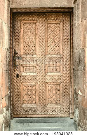 Lateral wooden door with carved patterns on the Armenian Apostolic Church in Echmiadzin