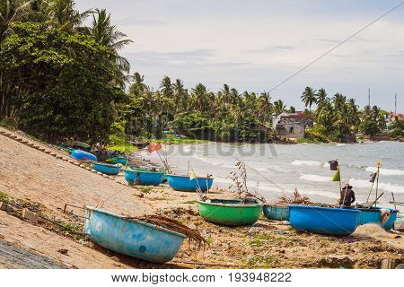 Muine Vietnam - May 26 2017: Fishing Village And Traditional Vietnamese Fishing Boats Docking On Seashore In Muine Vietnam.