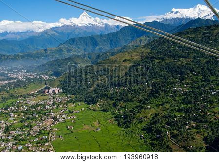 POKHARA, NEPAL. Flight on a hang glider (deltaplan). Shooting Pokhara and Green rice terraces of the Himalayas from the height of bird flight.
