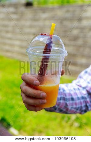 Hands Closeup Of Young Man With Watermelon Holding Glass Of Orange Juice