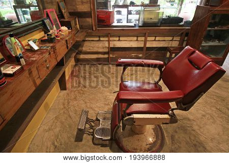 BANGKOK-THAILAND : MAY 18 2017 Old red chair in barber decoration at Baan Bangkhen museum
