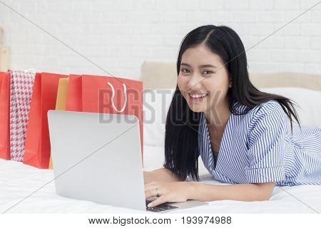 Beautiful asian women shopping with laptop online shopping protrait concept.