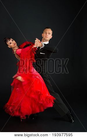 dance ballroom couple in a dance pose on black background. sensual professional dancers dancing walz tango slowfox and quickstep.